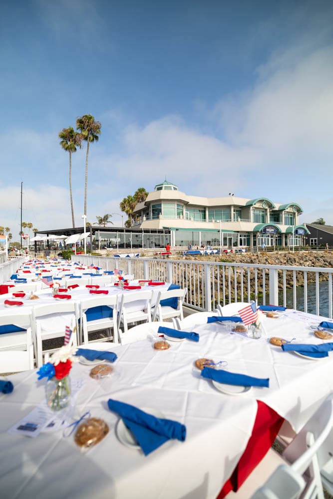 Red, white, and blue table settings on the dock before the celebration