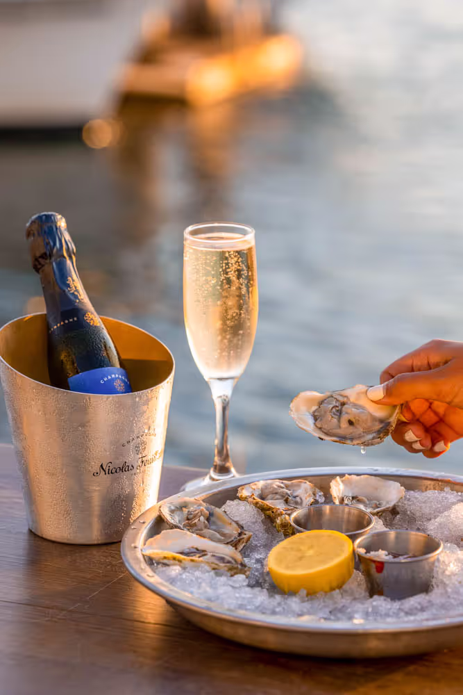 Champagne and oysters served at the waterfront