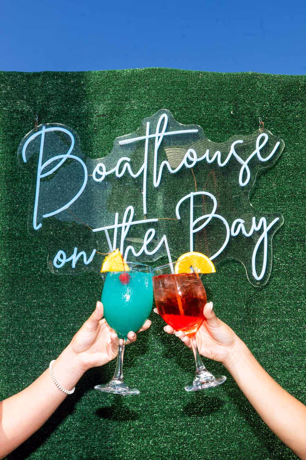 Cocktails near the Boathouse neon sign