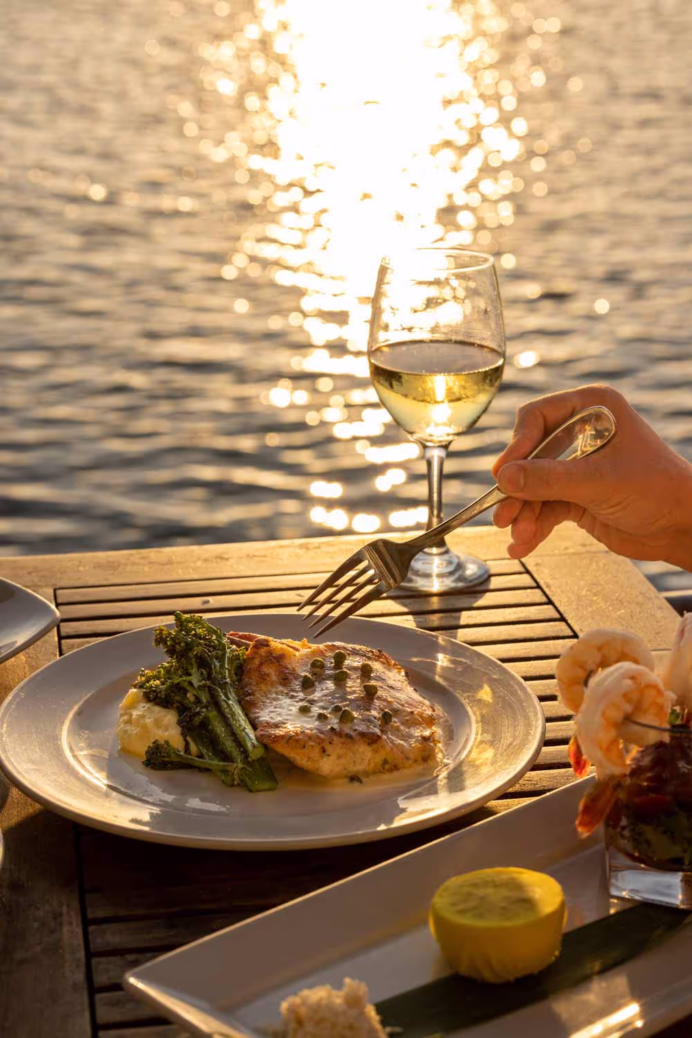 Sunset dinner with white wine at Boathouse on the Bay
