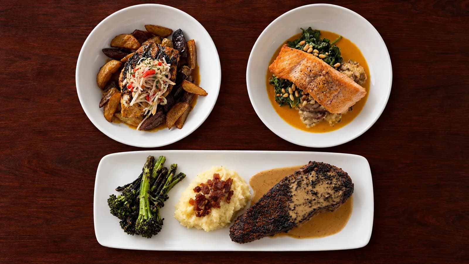 Three Mum’s Nostalgia dishes: blackened swordfish with fingerling potatoes and beets, black Angus New York pepper steak with mashed potatoes and broccolini, and salmon with spinach and mushroom mashed potatoes.