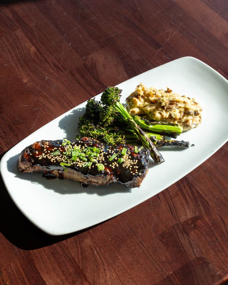 Teriyaki New York Strip with grilled broccolini at Boathouse on the Bay, from the original Mum's menu and returning at its 2004 price