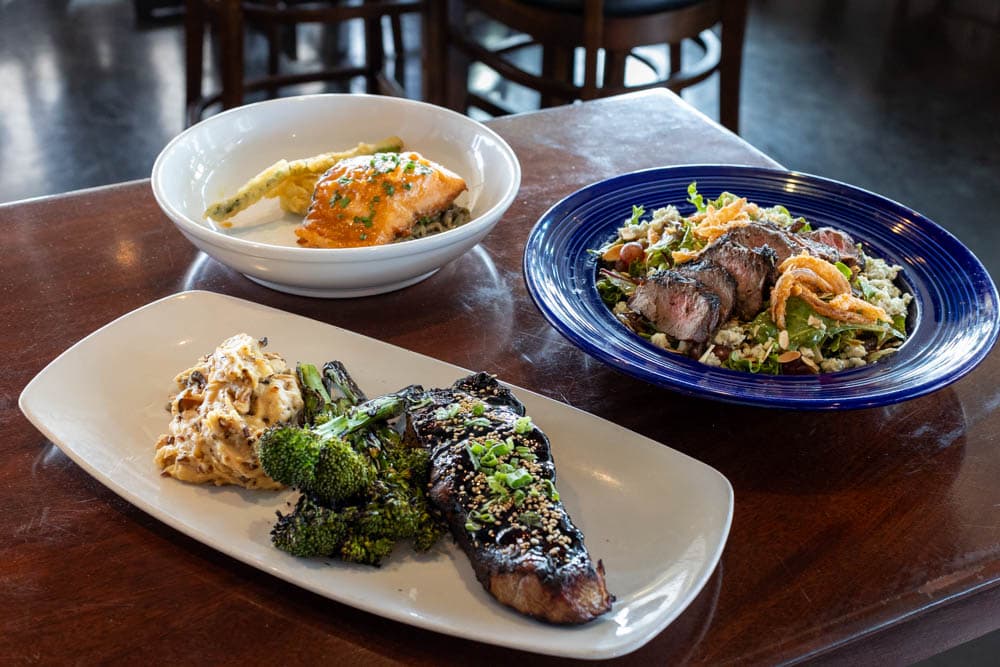 Three classic dishes from Mum's plated in the Boathouse on the Bay dining room